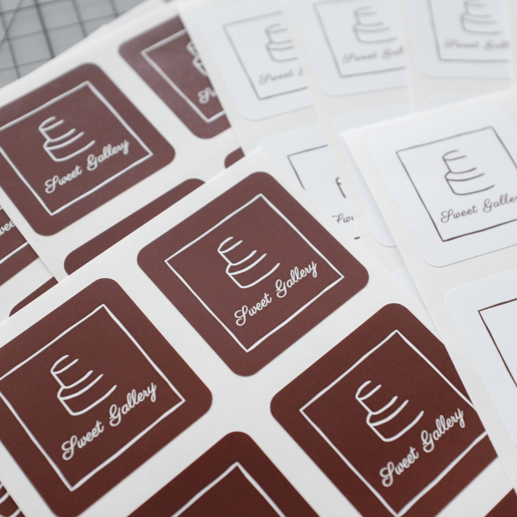 Square logo stickers printed on white vinyl sheet